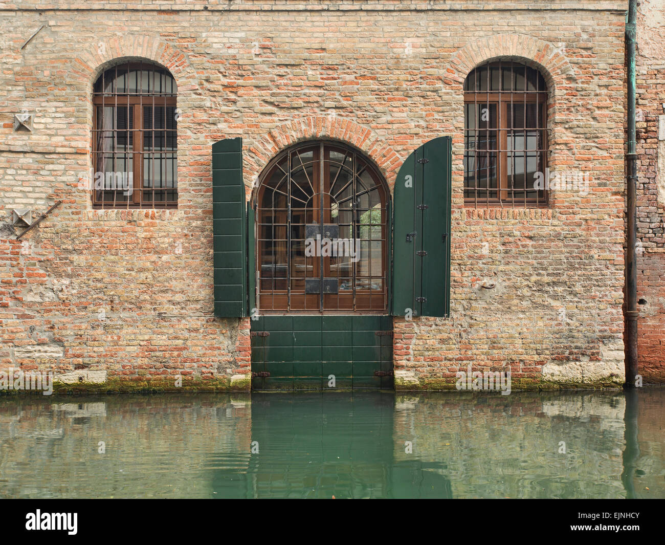 Venice, Italy door and windows at water level canal Stock Photo