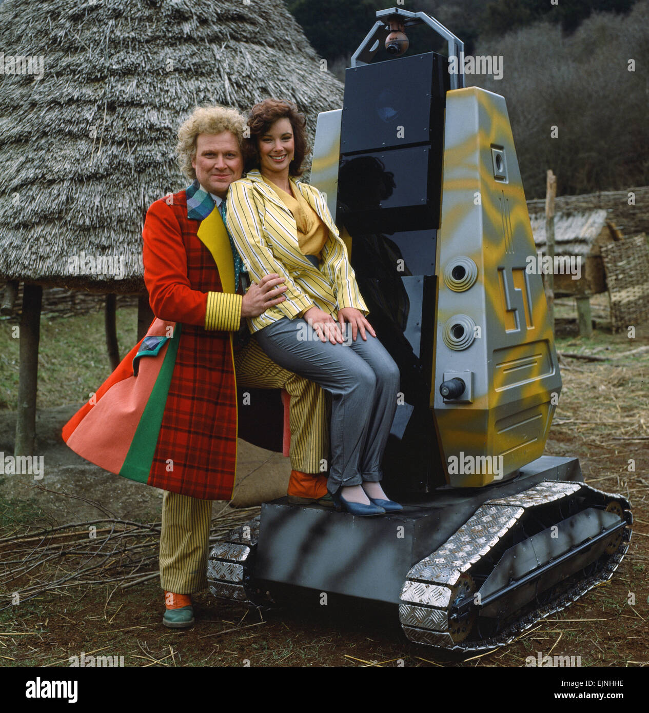 Actor Colin Baker, who plays Doctor Who in the BBC science fiction programme, photographed with his assistant Nicola Bryant who plays Perpugilliam 'Peri' Brown during filming at Butser Ancient Farm Project, Butser Hill, Hampshire for the story The Mysterious Planet, part of the larger Trial of A Time Lord narrative. 10th April 1986. Stock Photo