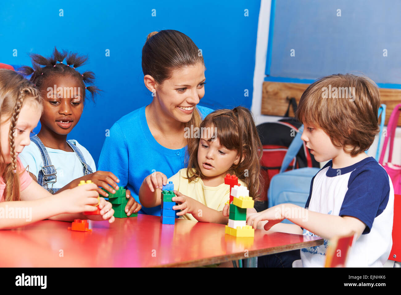 Teacher and children playing blocks hi-res stock photography and images ...