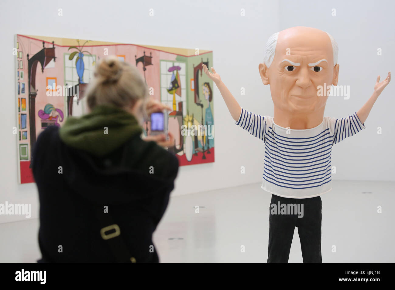 Hamburg, Germany. 30th Mar, 2015. A visitor takes a picture of the statue 'Untitled (Picasso)' made from colored glass fibre fabric is seen at the exhibition 'Picasso in contemporary art' at the Deichtorhallen exhibition hall in Hamburg, Germany, 30 March 2015. The exhibition with 200 works by renowned contemporary artists will run from 01 April until 12 July 2015. Photo: Malte Christians/dpa/Alamy Live News Stock Photo