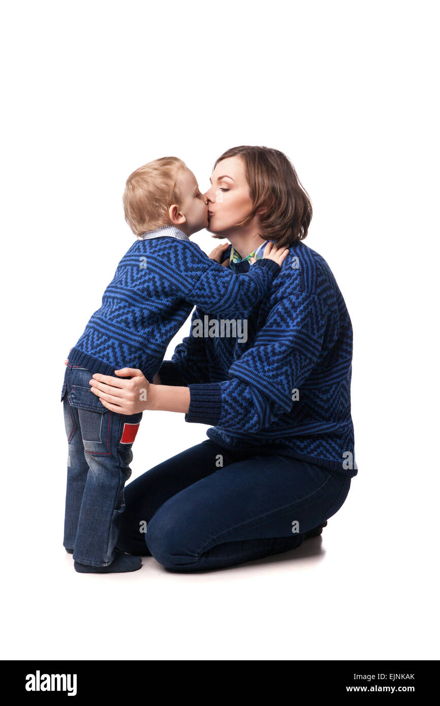 A young boy hugging and kissing his mom, isolated for white