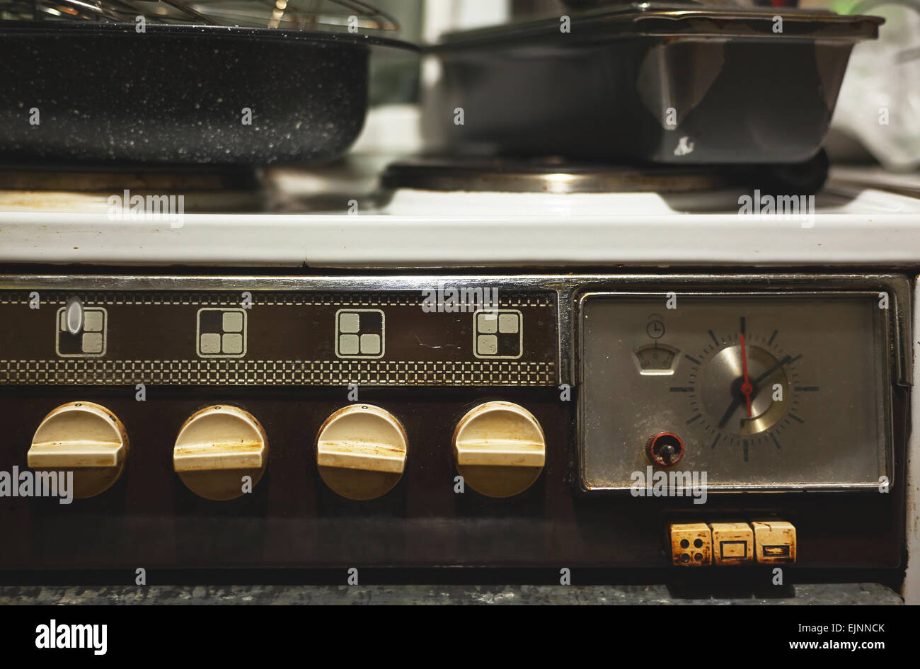 Details of an old stove, dirty of cooking, with dishes on top. Stock Photo