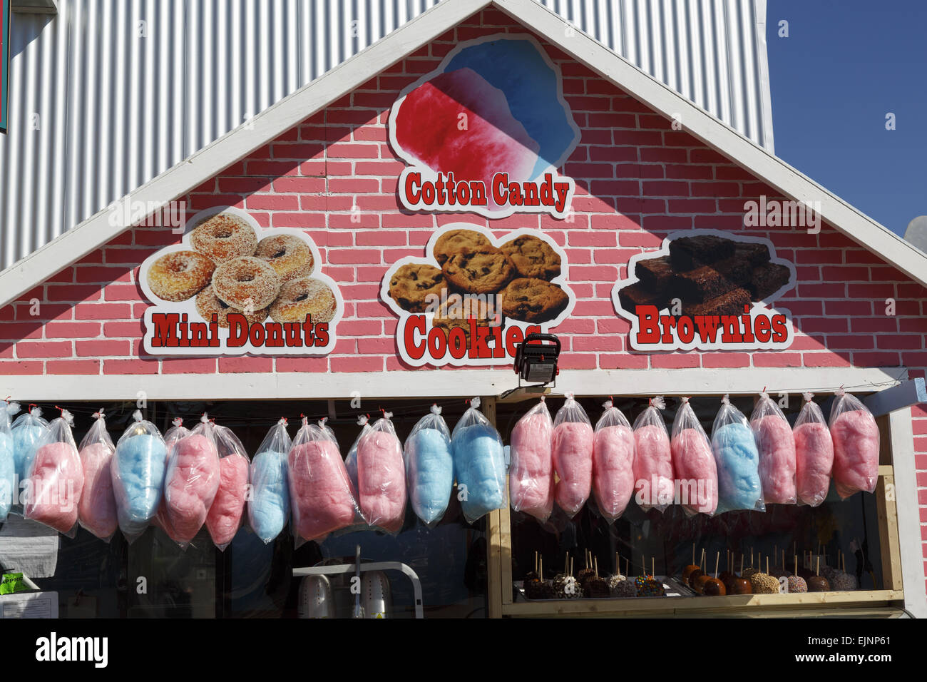Cotton candy hanging over top of a fairground food stall Stock Photo Alamy