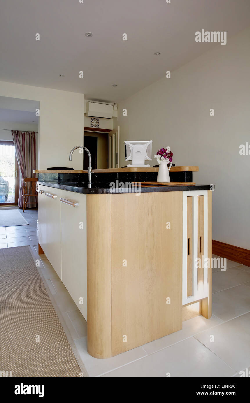 A modern cream kitchen island inside a home in the UK. Stock Photo