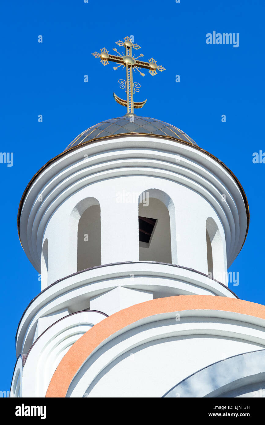 Golden dome of Russian orthodox church with cross against blue sky ...