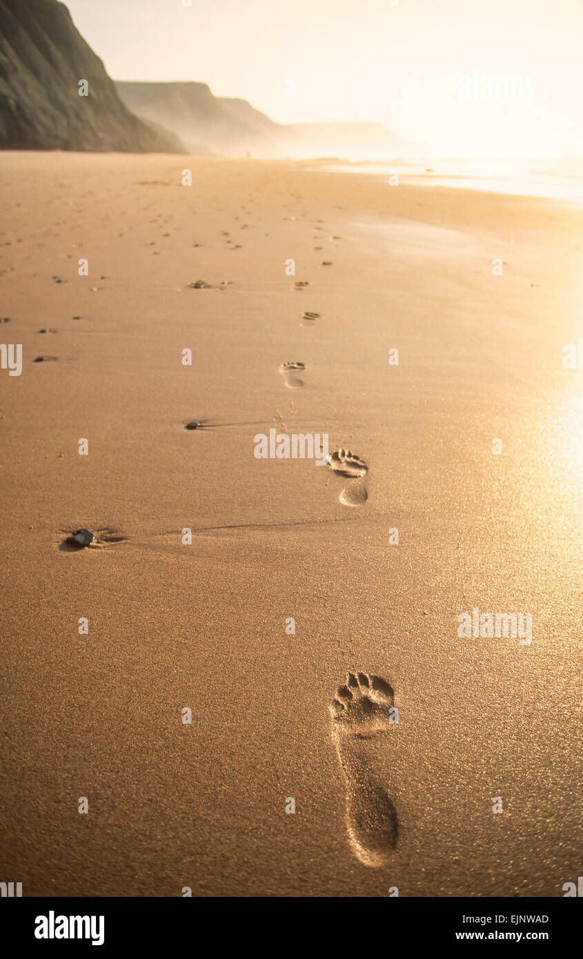 Footprints in the sand at sunset Castelejo Beach Algarve Portugal EU Europe Stock Photo