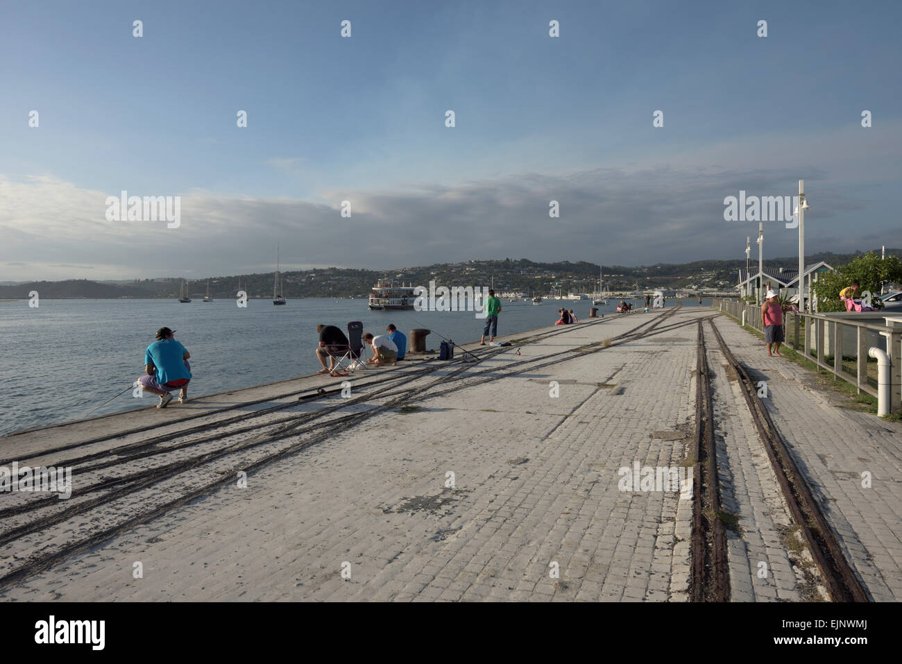 anglers at a pier in the late afternoon sun, Knysna, South Africa Stock Photo