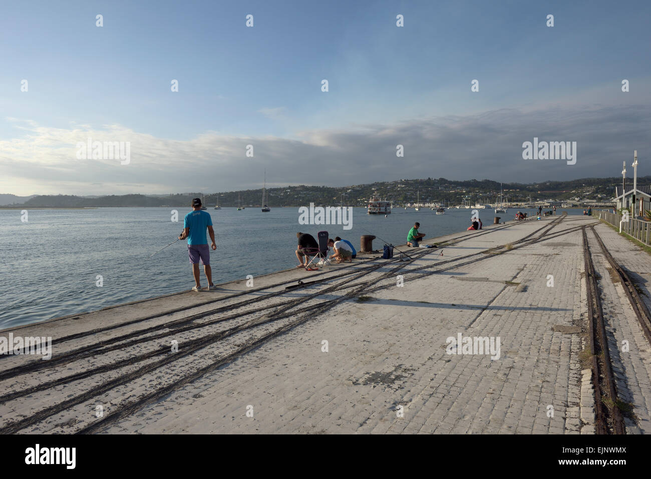 anglers at a pier in the late afternoon sun, Knysna, South Africa Stock Photo