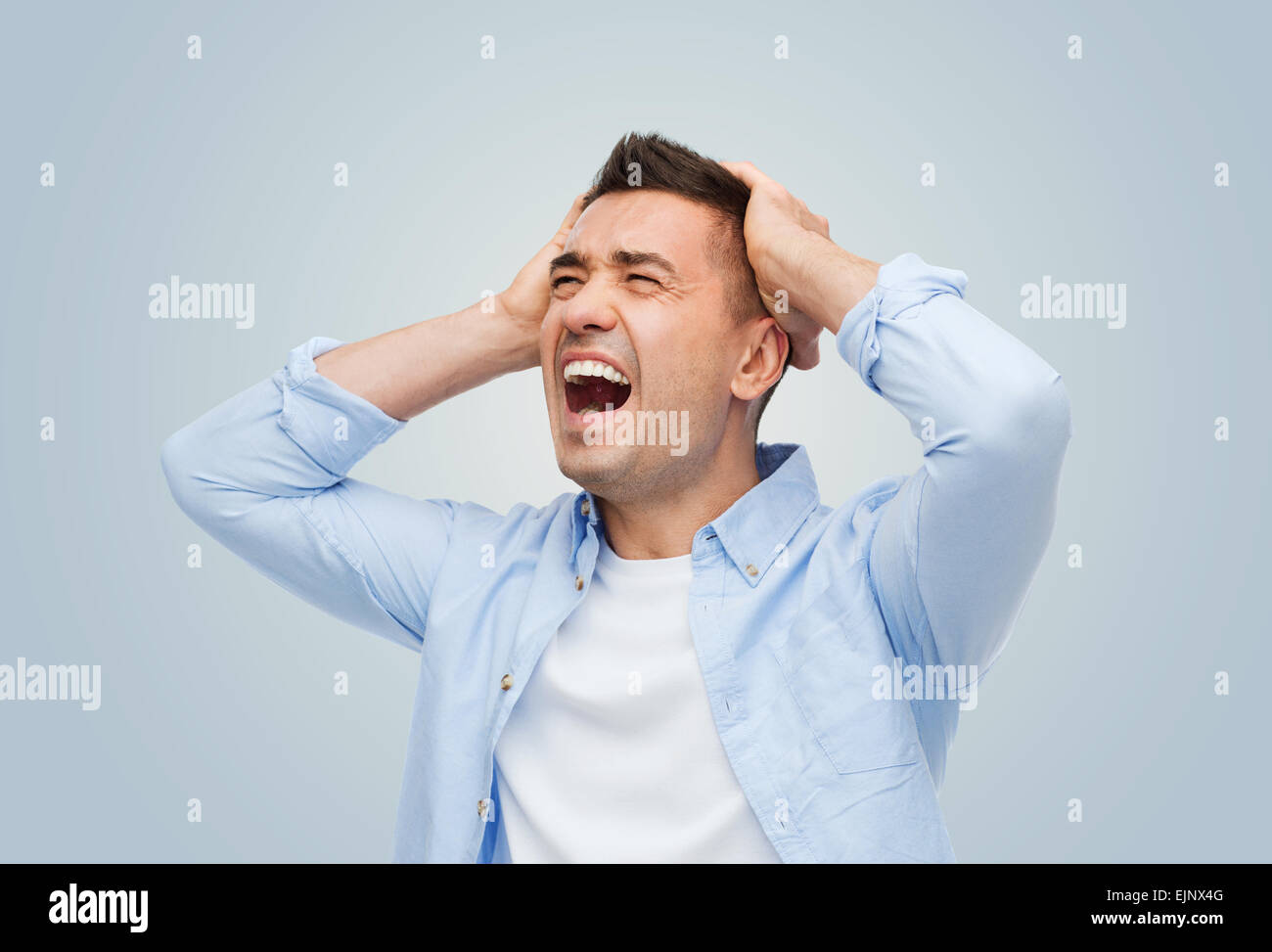 unhappy man with touching his head and screaming Stock Photo - Alamy