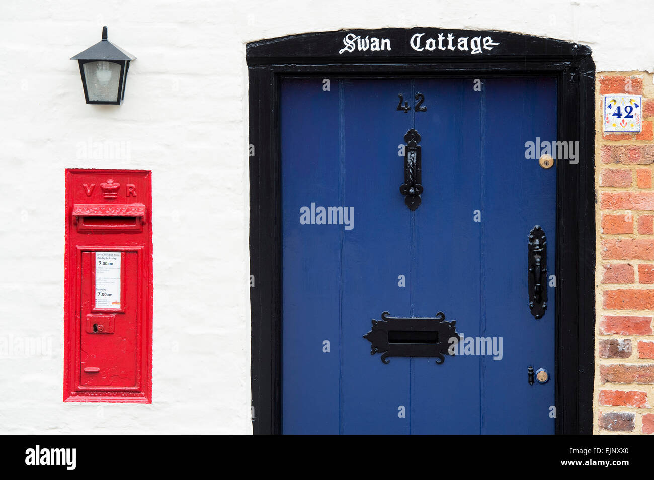 Blue Cottage Front Door And Red Post Box Uk Stock Photo