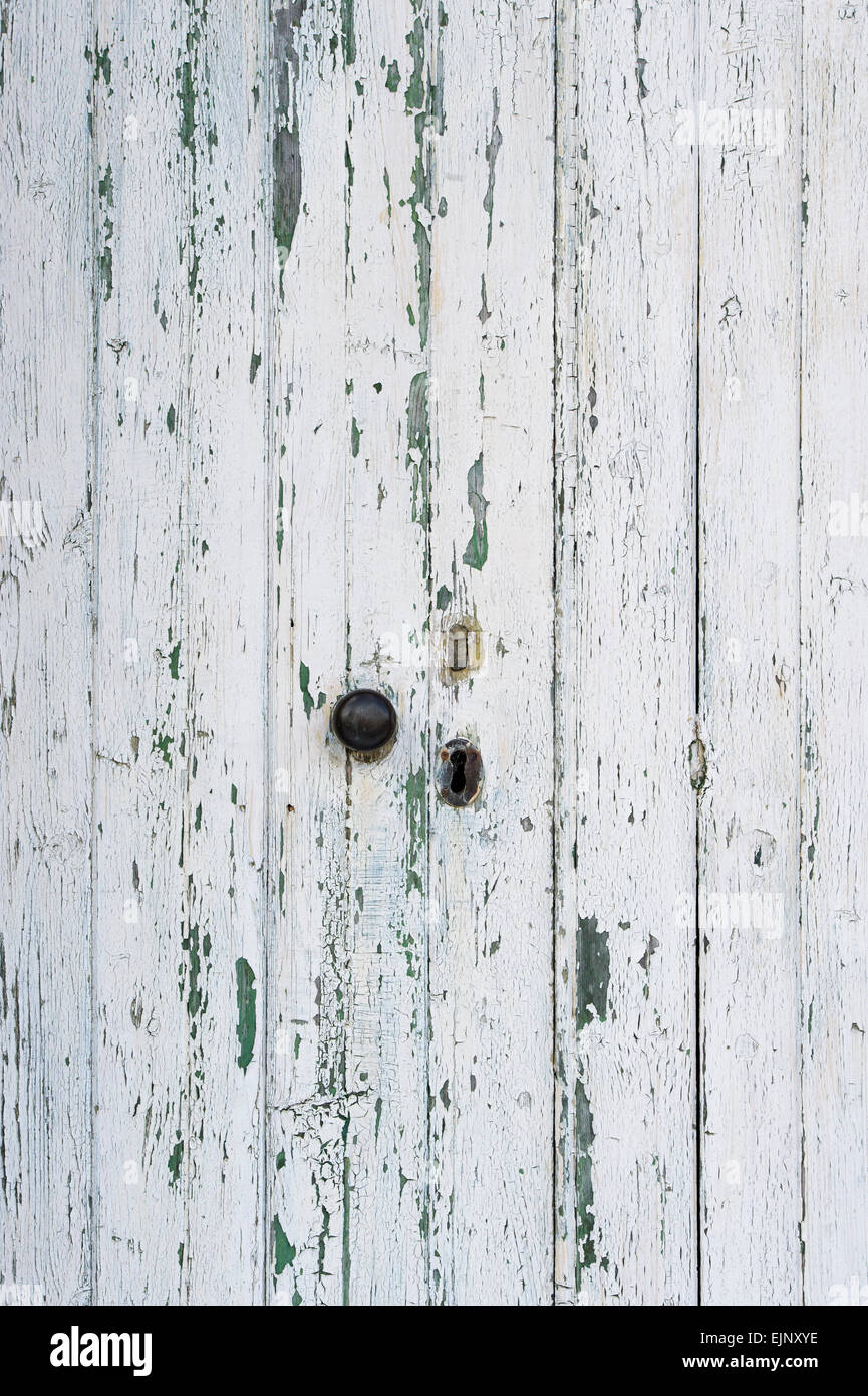 Old painted white wooden doors with peeling paint texture Stock Photo