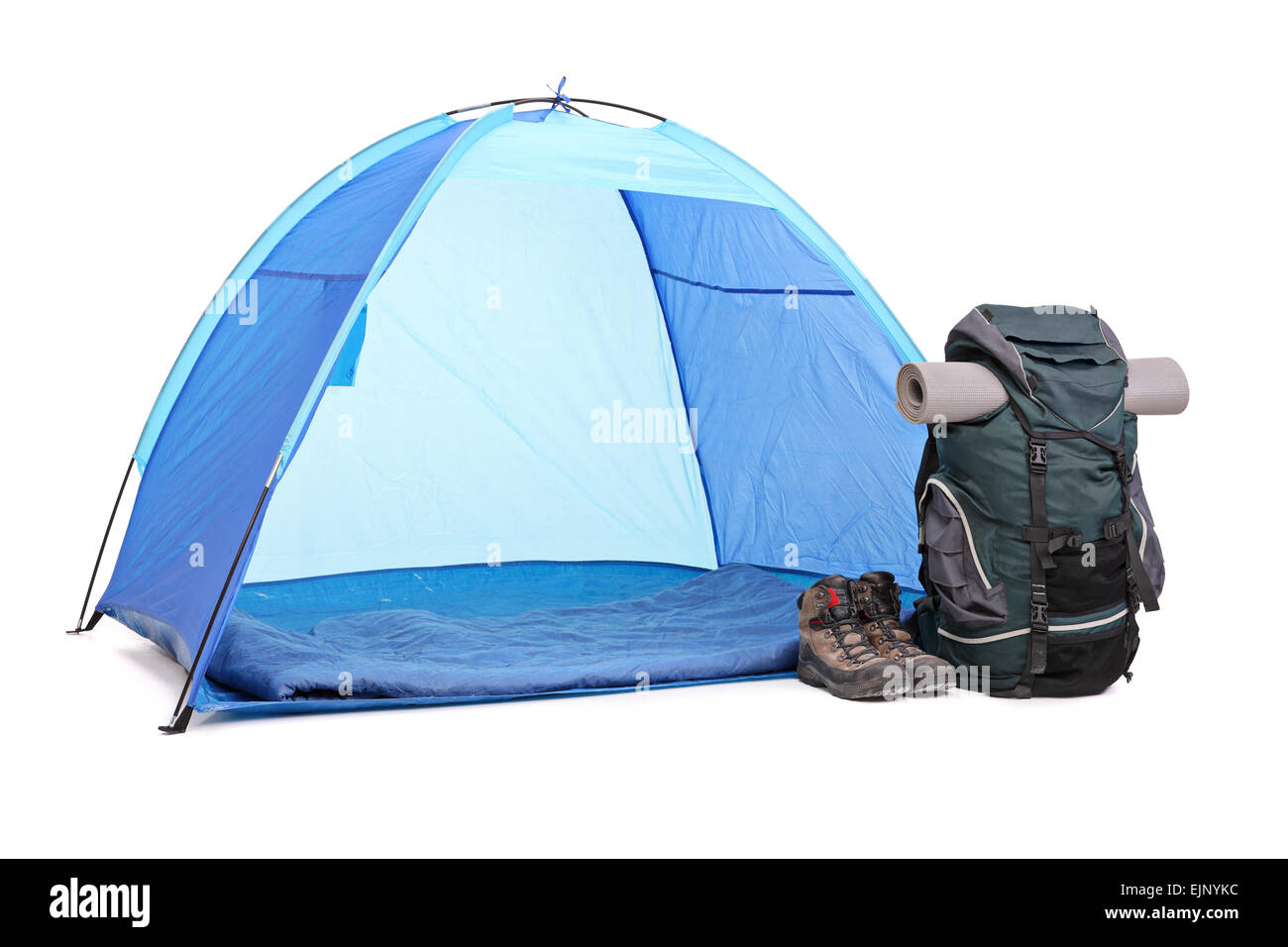 Studio shot of a blue tent, a green rucksack and a pair of boots left next to the tent isolated on white background Stock Photo