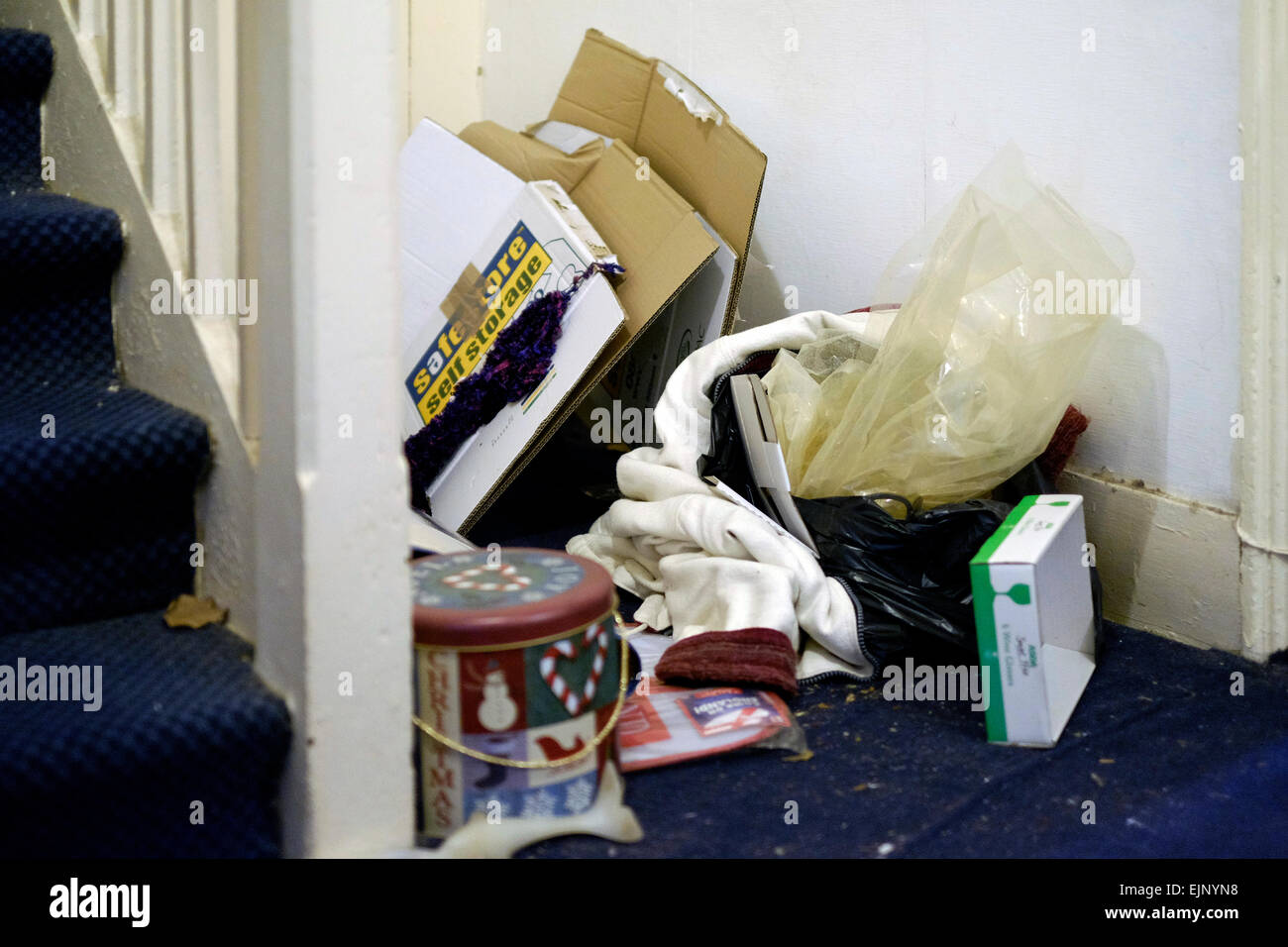 piles of rubbish left behind in a filthy left by vacating tenants Stock Photo