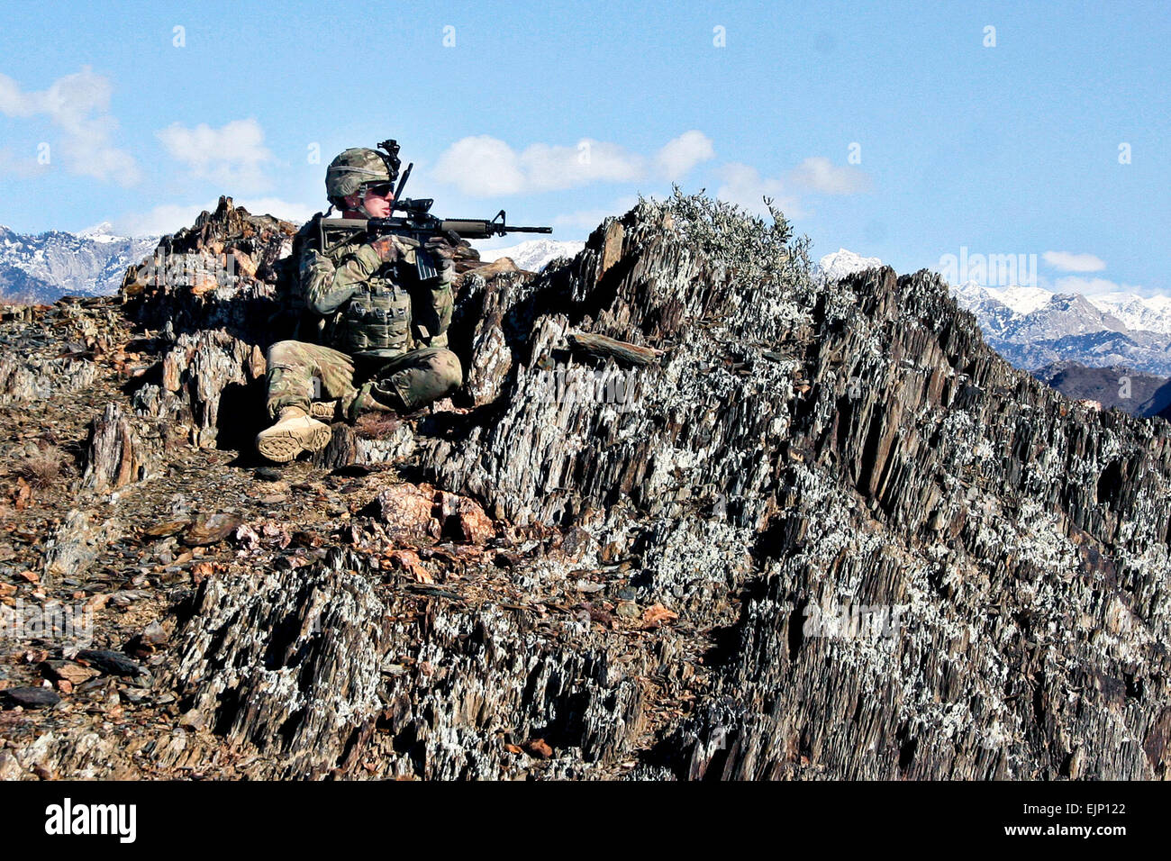 - U.S. Army Sgt. Nick Andrews, an infantry squad leader with Company C, 1st Battalion, 133rd Infantry Regiment, from Marshalltown, Iowa, looks into the valley from a mountaintop outside the village of Nengaresh, Afghanistan, Jan. 21. Soldiers from Co. C, joined Afghan National Army Soldiers from Weapons Company, 1st Battalion, 201st Infantry Corp, on the patrol. After seven hours of dismounted searching through rugged terrain, Co. C and their Afghan counterparts located an improvised explosive device along Route Iowa, thanks to a tip from someone in the area of Tupac, Afghanistan.  U.S. Army S Stock Photo