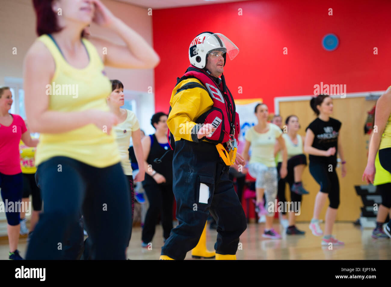 Crew members in full immersion survival kit taking part in a 'Zumbathon' fund raising event at Aberystwyth University sports  centre in aid of the Royal National Lifeboat institution (RNLI) Stock Photo
