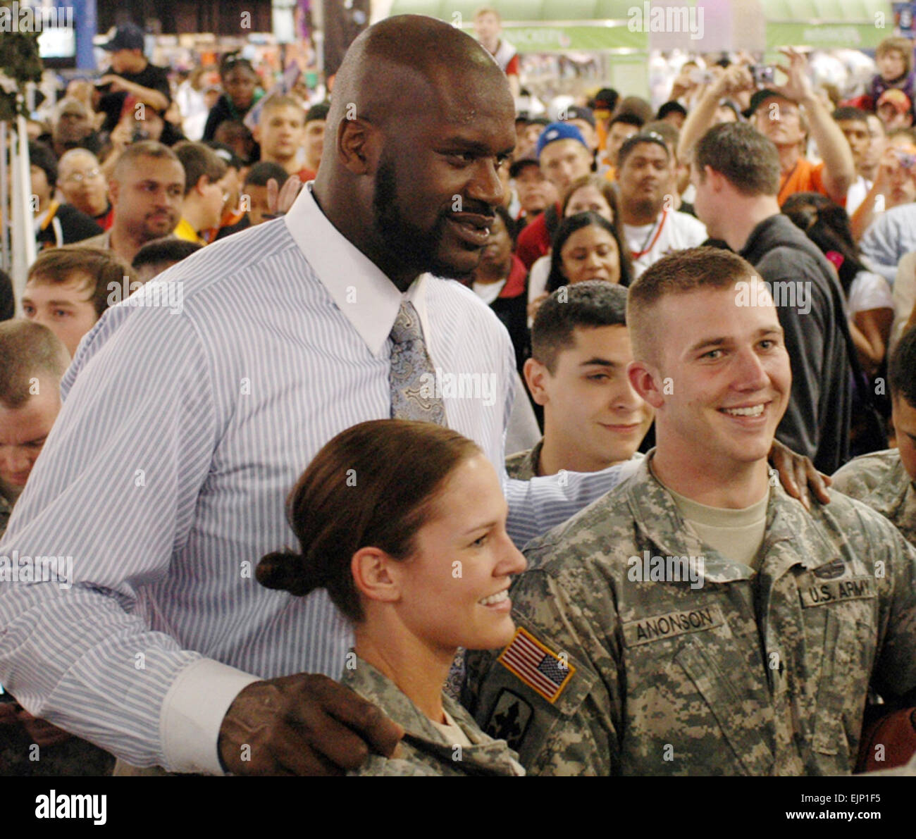 Army National Guard members Staff Sgt. Maygen Matson, left, and Spc. Taylor Anonson pose for a photo with National Basketball Association superstar Shaquille O'Neal during NBA All-Star Weekend in Phoenix, Feb. 15, 2009.  Tech. Sgt. Angela Walz. Stock Photo