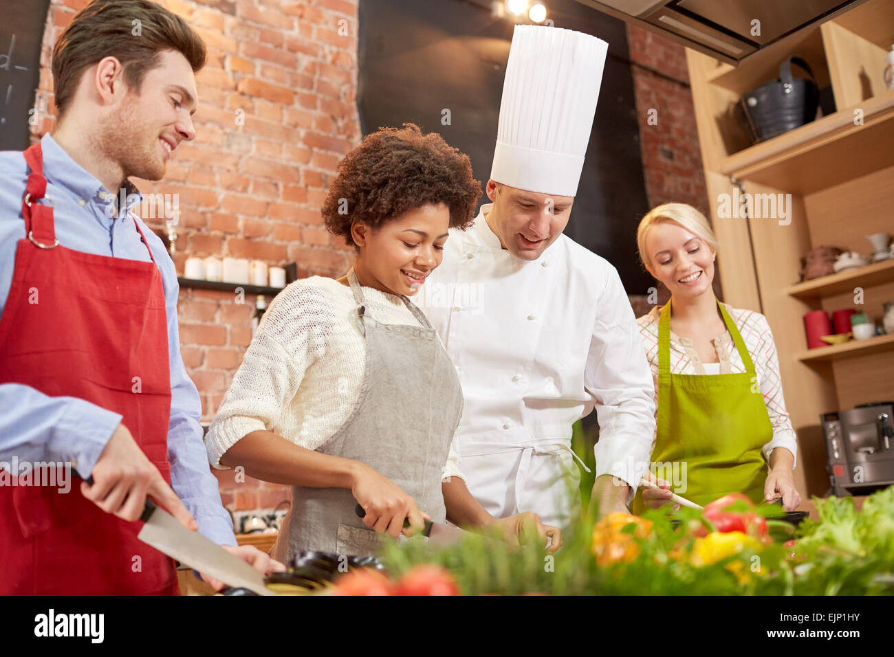 happy friends and chef cook cooking in kitchen Stock Photo Alamy