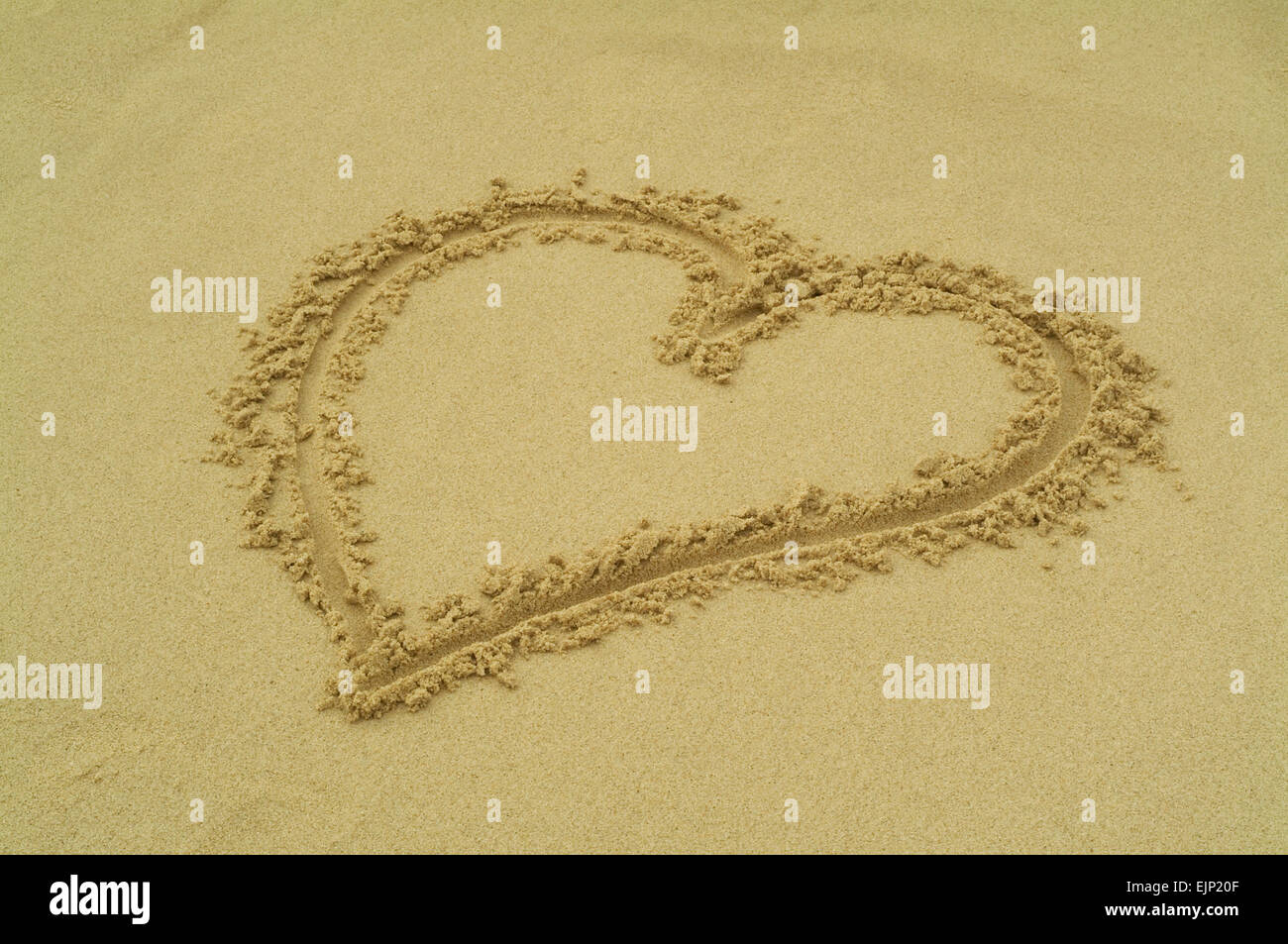 A heart painted in the sand beach Stock Photo