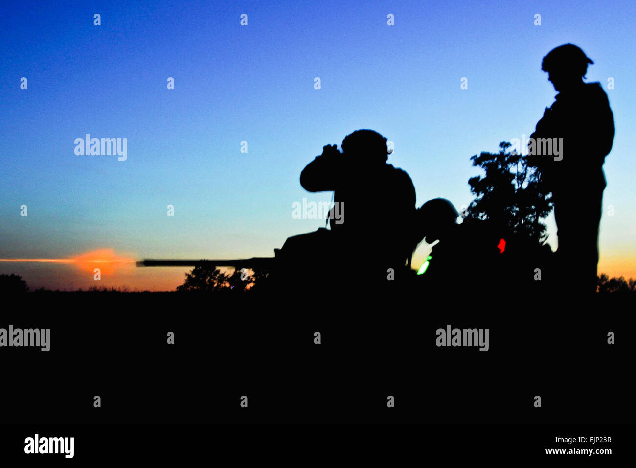 U.S. Army Soldiers and U.S. Navy sailors assigned to a provincial reconstruction team fire a .50-caliber machine gun during night weapons qualifications at Camp Atterbury as a part of pre-deployment training. Ten PRTs are preparing for an upcoming deployment to Afghanistan to support security, governance and socioeconomic development. Stock Photo