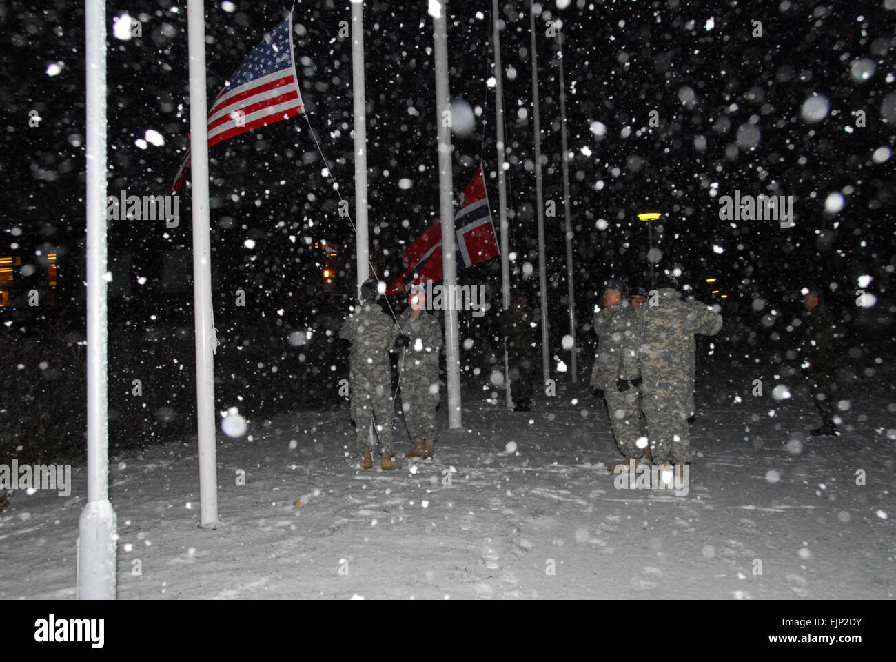 U.S. Army Soldiers from the Minnesota Army National Guard and Norwegian Home Guard members raise their flags at Camp Vearnes, Norway, for the 35th Annual U.S./Norwegian Troop Reciprocal Exchange Feb. 13, 2008.  The guardsmen will take part in winter training and a unique cultural exchange while on this two week deployment.   Tech Sgt. Jason Rolfe Stock Photo