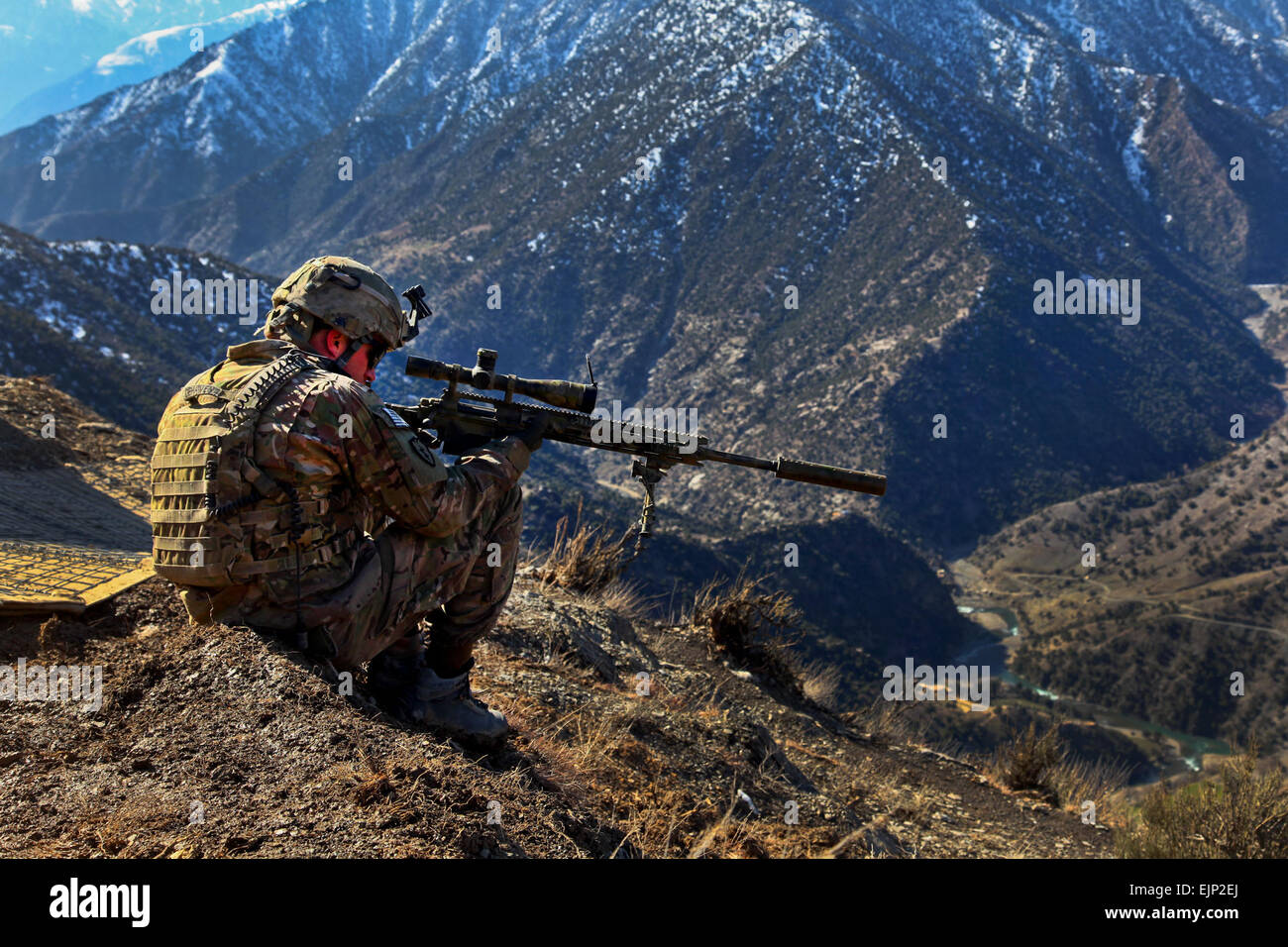U.S. Army Cpl. Kevin Dehaven, Sniper Team Leader, Headquarters and Headquarters Company, 2nd Battalion, 27th Infantry Regiment, 3rd Brigade Combat Team, 25th Infantry Division, provides security, at Observation Post Mangol, Feb. 8, 2012, in the Nari district, Kunar province, Afghanistan. Stock Photo