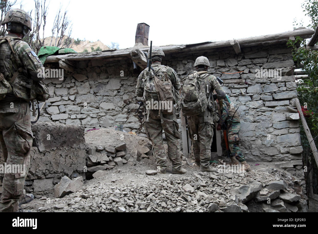 U.S. Army soldiers from B Troop, 6th Squadron, 4th Cavalry Regiment, 3rd Brigade Combat Team, Task Force Duke enter a house to search it during Operation Tofan 2 in Suri Khel, Afghanistan, Sept. 15, 2011. The mission objective was to clear insurgents from the town of Suri Khel and prevent them from returning. Stock Photo