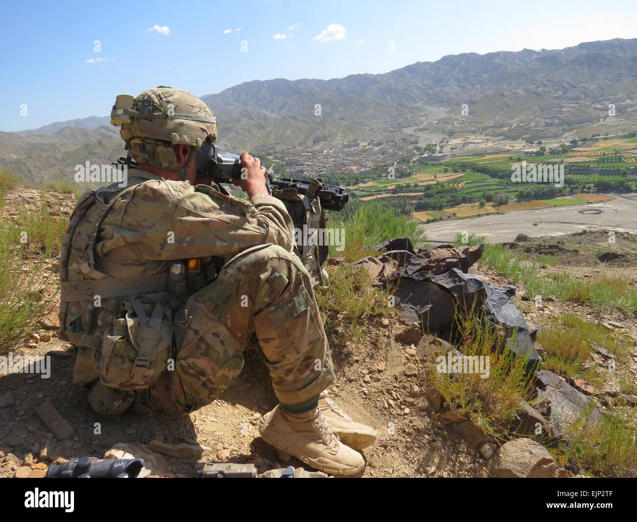 Staff Sgt. Timothy Blackman, a squad leader in Company D, 1st Battalion, 28th Infantry Regiment, 4th Infantry Brigade Combat Team, 1st Infantry Division, provides over watch  security while the Afghan National Army conducts a shura with the people in Pirkowti Valley with the Paktika Province, Jul 1. U.S. Army Courtesy Photo Stock Photo