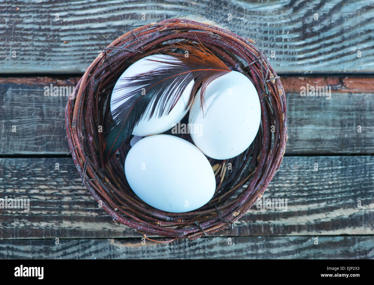 chicken eggs in the nest and on a table Stock Photo - Alamy