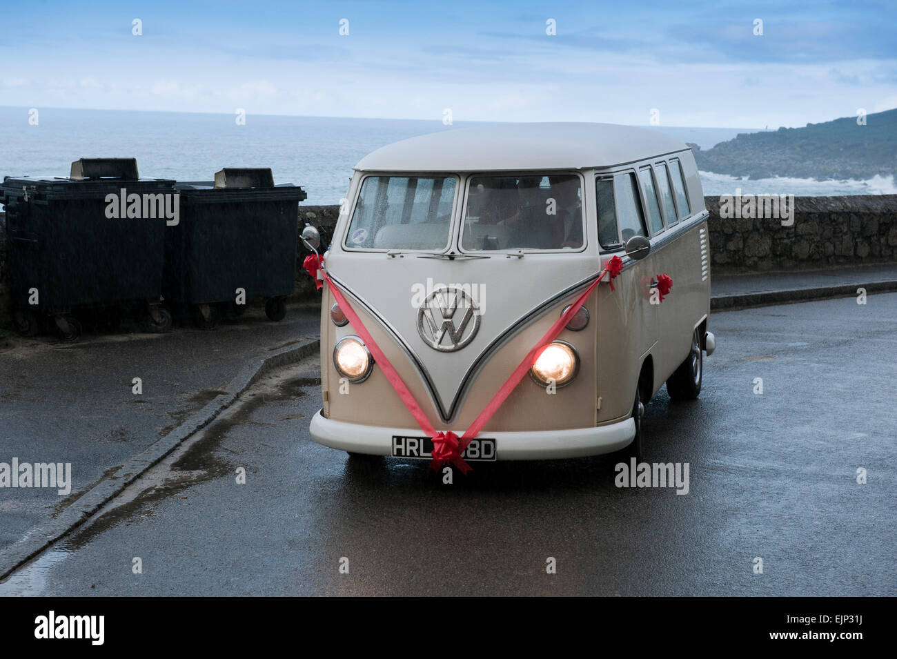 Vintage Volkswagen VW Bus ca. 1965 decorated for a wedding on a rainy day in St. Ives Cornwall England UK Europe Stock Photo