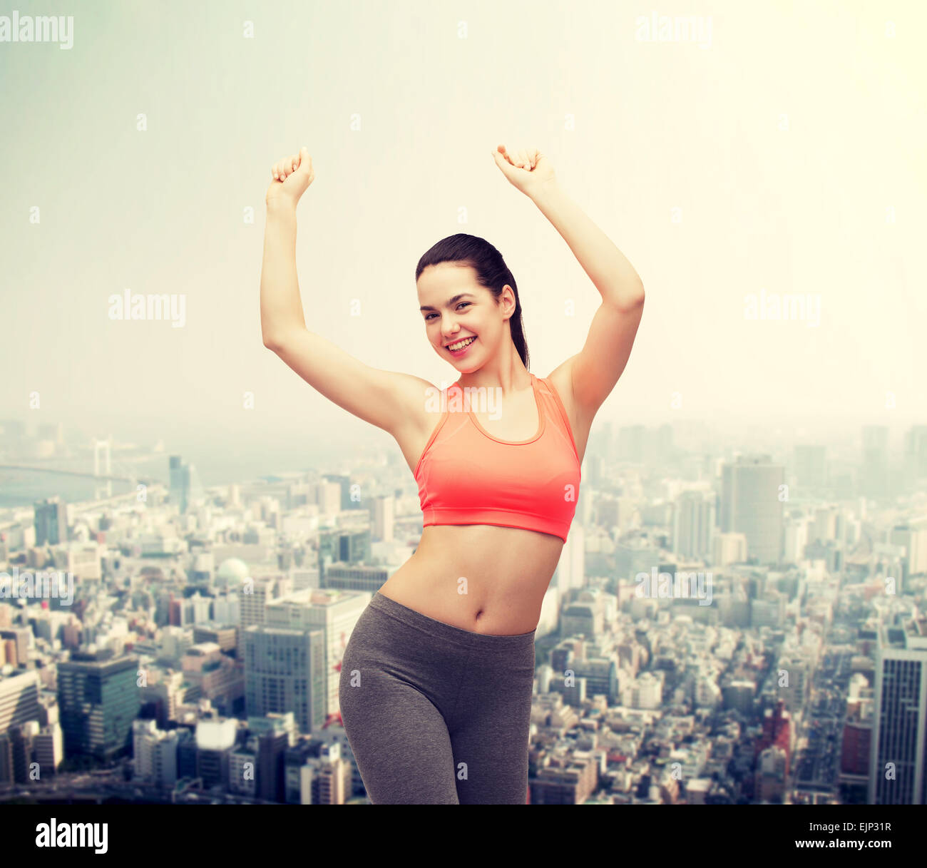 smiling teenage girl in sportswear dancing Stock Photo