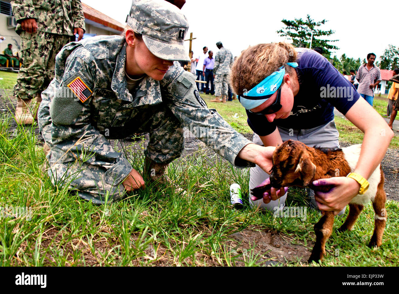 Army Capt. Shannon McLean and Helle Hydeskov, a World Vets volunteer veterinarian, examine a baby goat’s leg as part of a veterinary civic action project during Pacific Partnership 2012. Now in its seventh year, Pacific Partnership is an annual U.S. Pacific Fleet humanitarian and civil assistance mission U.S. military, host and partner nations, non-governmental organizations and international agencies designed to build stronger relationships and disaster response capabilities in the Asia-Pacific region.  Camelia Montoy Stock Photo