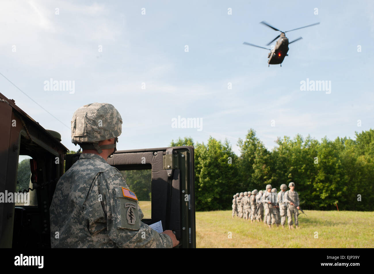 Sgt. 1st Class Marcum James, with the 244th Aviation Brigade and a native of Easton, Pennsylvania, watches as a CH-47 Chinook approaches a pick-up zone at the 2014 U.S. Army Reserve Best Warrior Competition, June 24, at Joint Base McGuire-Dix-Lakehurst, N.J. The helicopter and its crew are from Bravo Company, 5th Battalion General Support, 159th Regiment, 244th Aviation Brigade, 11th Theater Aviation Command, Fort Eustis, Va.  Timothy L. Hale Stock Photo