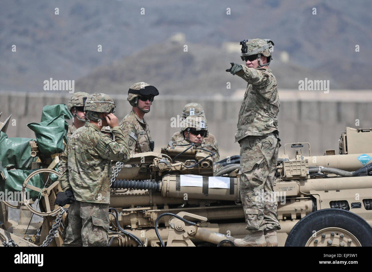 U.S. Army 1st Sgt. Michael Strate right, C-Battery, 1st Battalion Air Assault, 377th Field Artillery Regiment, Task Force Spartan Steel, prepares to transport the M777 howitzer from Forward Operating Base Salerno to Combat Outpost Chamkani March 28. L Spc. Eric-James Estrada Stock Photo