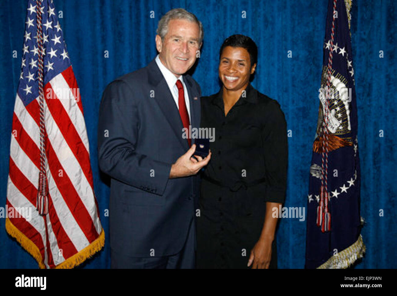 President George W. Bush stands with Keela Carr, a 35-year-old fitness and athletic trainer from Orlando, shortly after his arrival in the Florida city Wednesday, Aug. 20, 2008.  Ms. Carr was recognized by the U.S. Army's Freedom Team Salute Program and named its 500th Volunteer Ambassador.  The Freedom Team Salute is a U.S. Army progam that recognizes citizens for supporting Army veterans.  White House photo by Eric Draper Stock Photo