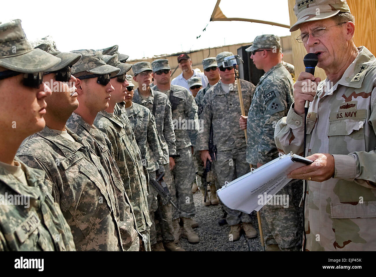 U.S. Navy Adm. Mike Mullen, chairman of the Joint Chiefs of Staff, reads the citations for seven Soldiers receiving Purple Heart honors on Forward Operating Base Ramrod, July 17, 2009, for wounds sustained in Helmand province, Afghanistan.  U.S. Navy Petty Officer 1st Class Chad J. McNeeley Stock Photo