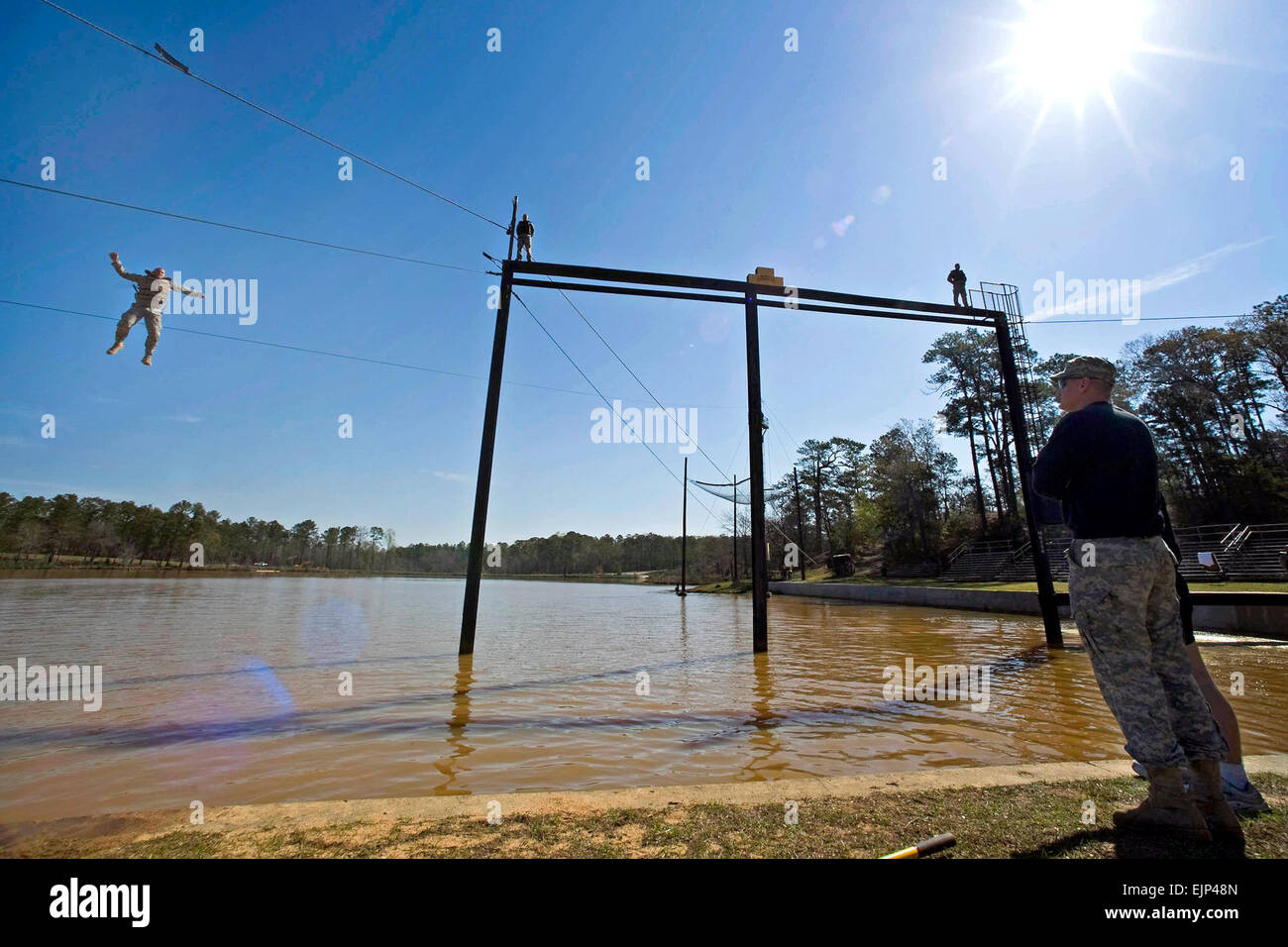 A Ranger Cadre watches a trainee drop 40 feet into a lake during his  performance in the Combat Water Survival Assessment course on Fort Bennning  Georgia. The CWSA consists of a 40