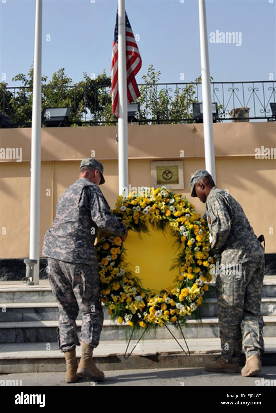 Army Maj. Gen. Robert Cone, commander of Combined Security Transition Command - Afghanistan, and Army Sgt. Maj. Gregory Valcin, acting CSTC-A command sergeant major, place a wreath below a flag flown at half-staff during a remembrance ceremony at Camp Eggers in Kabul, Afghanistan, Sept. 11, 2008 Stock Photo
