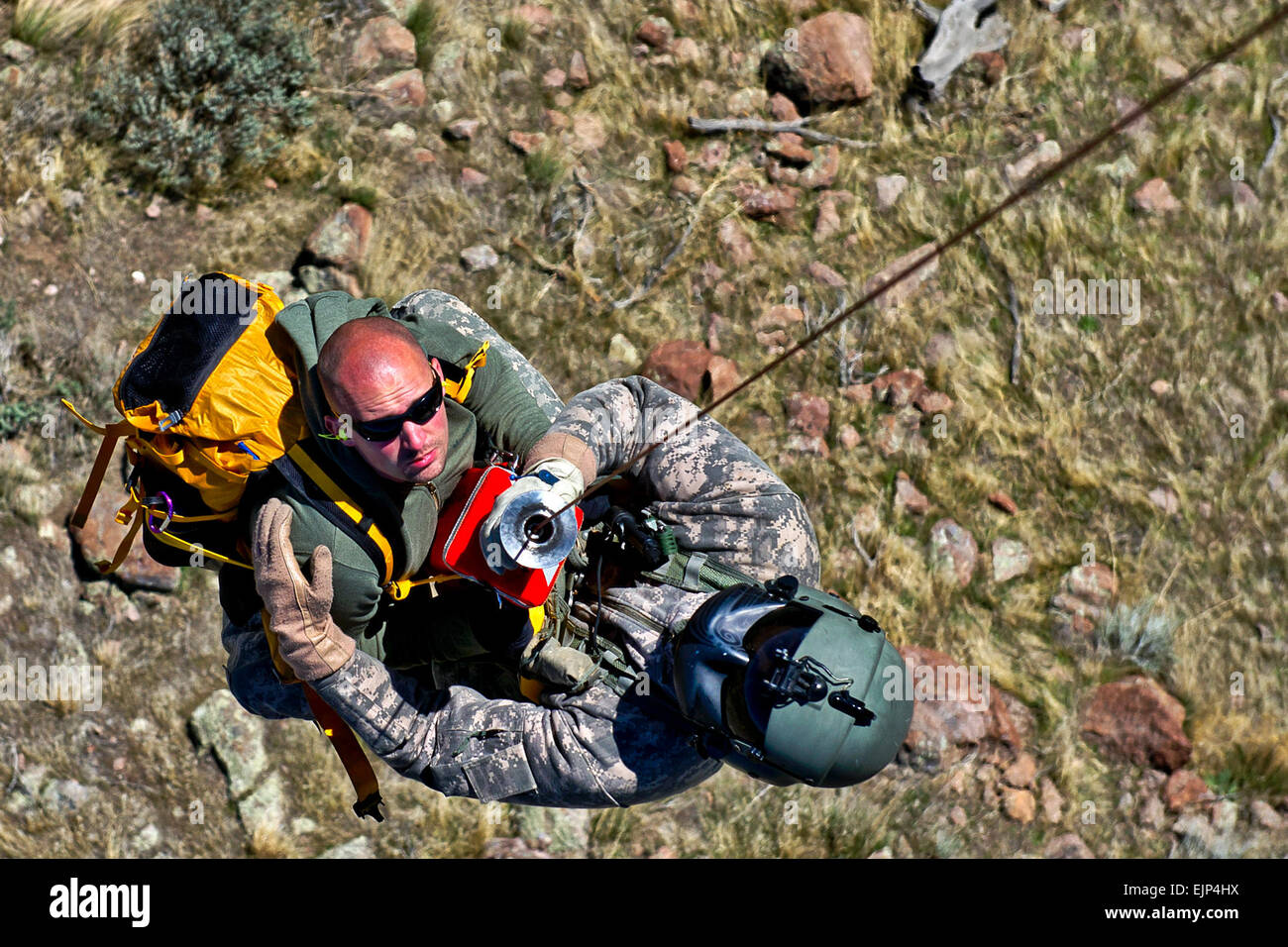 U.S. Army Sgt. Nathan McLaughlin, a standardization instructor from C Company, 1-171 Medevac, Utah Army National Guard, West Jordan, Utah, rescues a lost hiker, Staff Sgt. Christian Larsen, a medic from C Company, 1-171 Medevac, Utah Army National Guard, West Jordan, Utah, during a search and rescue training exercise, on Camp W.G. Williams, Riverton, Utah, April 3, 2012. Stock Photo