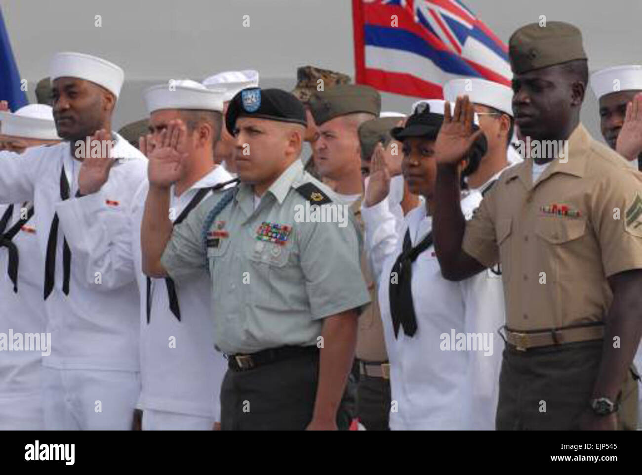 U.S. Army Sgt. 1st Class Jose Vargas, center, joined 58 Sailors and Marines in taking the oath of citizenship, administered by U.S. Federal District Judge Thomas J. Whelan April 4, 2007, in San Diego, Calif. The ceremony held aboard the amphibious transport dock ship USS Cleveland LPD 7 in San Diego.  Cmdr. Jane Campbell Stock Photo