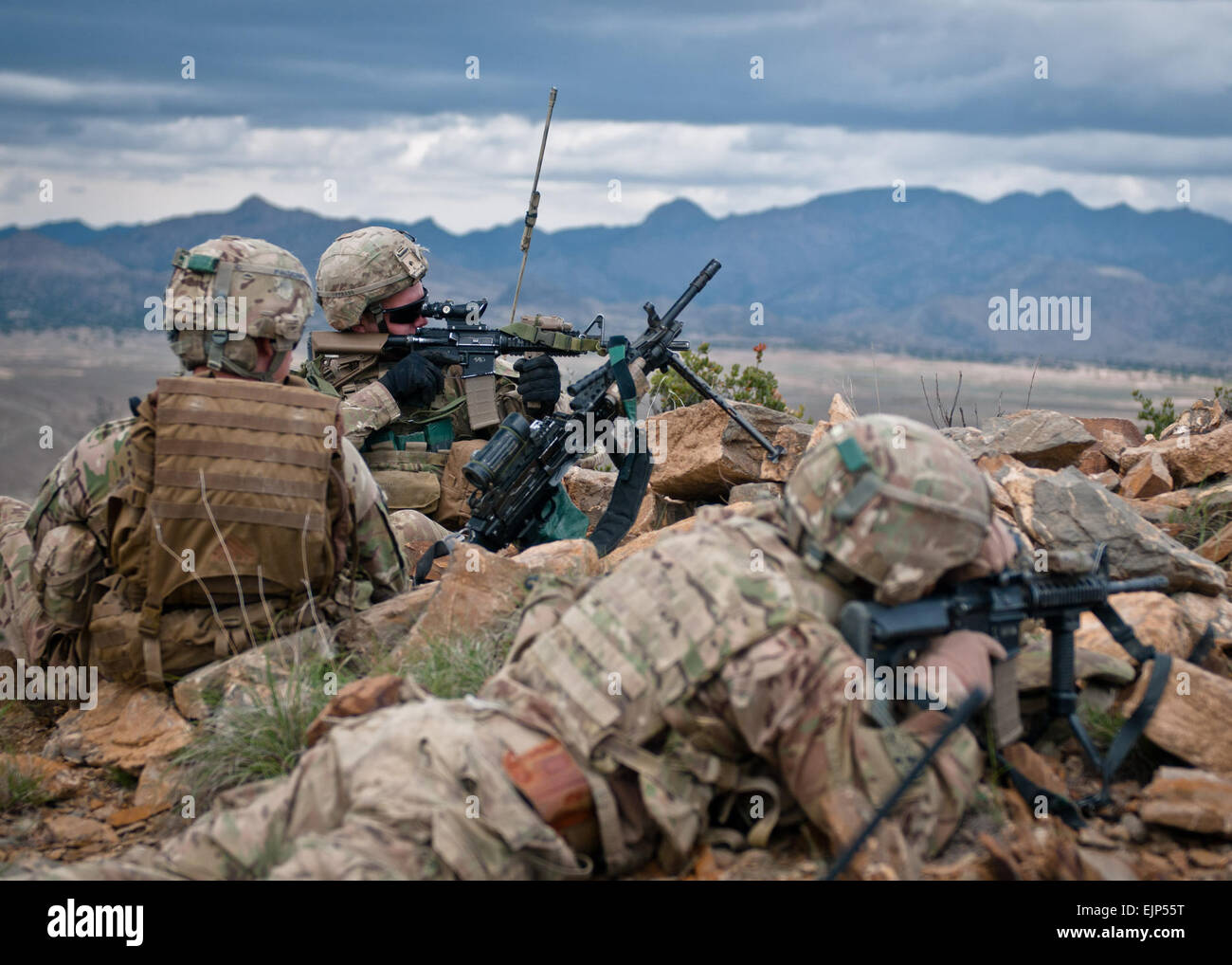 Spc. Jacob Tippmann, infantryman with Company C, 3rd Battalion, 66th Armor Regiment, Task Force 2-28, 172nd Infantry Brigade, scans an adjacent hilltop outside of Forward Operating Base Tillman. Located just 3.5 kilometers from the border, the terrain around Tillman is some of the most rugged, remote and hostile terrain in Paktika province, Afghanistan. Stock Photo