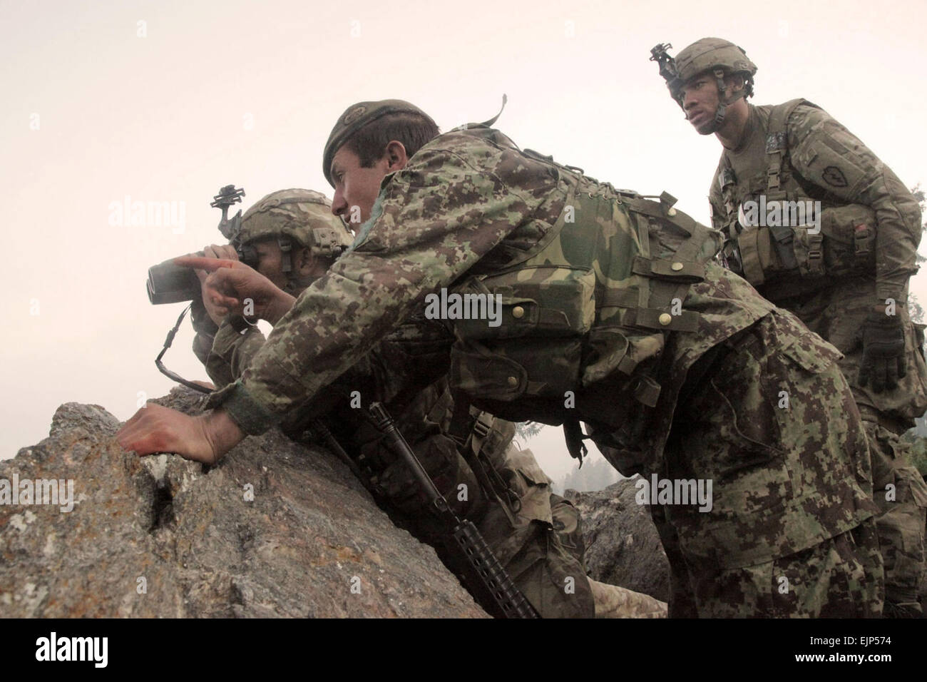 U.S. Army Soldiers with Delta Company, 2nd Battalion, 35th Infantry Regiment and an Afghan National Army soldier 2nd from right search a valley for insurgent activity during Operation Hammer Down in the Watapur district of Kunar province, Afghanistan, on June 26, 2011.   Spc. Tia Sokimson, U.S. Army.  Released Stock Photo