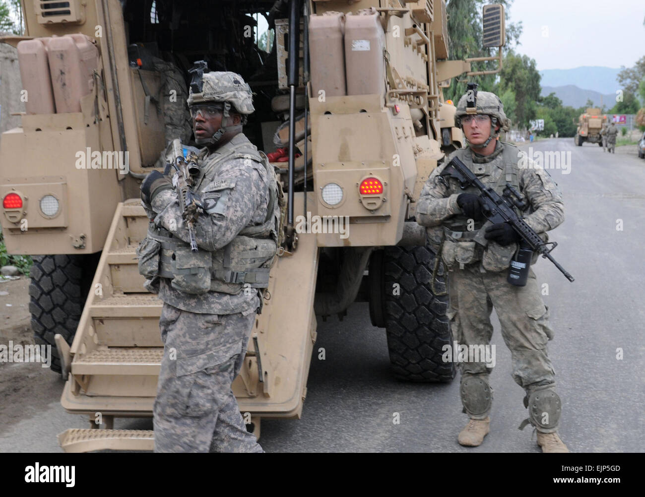 U.S. Army Cpl. Mark D. Jennings left and Spc. Ryan A. Quattlebaum, both team leaders with 1st Platoon, Baker Company, 2nd Battalion, 327th Infantry Regiment, provide security during a unit visit to Kutgay village, Kunar province, Afghanistan, on Aug. 25, 2010.   Staff Sgt. Gary A. Witte, U.S. Army.  Released Stock Photo