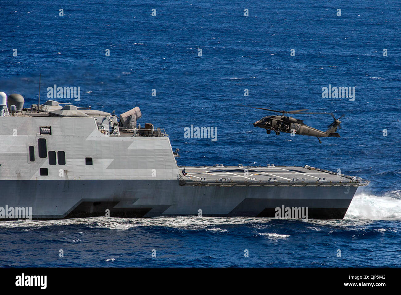 A U.S. Army 25th Combat Aviation Brigade UH-60 Blackhawk helicopter crew conducts deck landing qualifications on the littoral combat ship USS Fort Worth LCS 3 off the coast of Oahu, Hawaii, Nov. 25, 2014.  MC2 Antonio P. Turretto Ramos Stock Photo