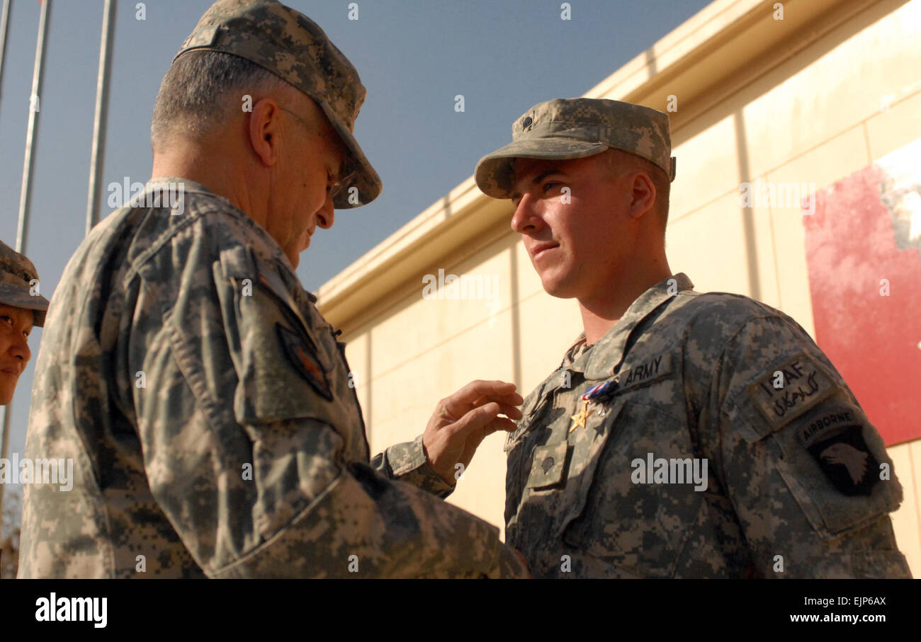 KHOWST PROVINCE, Afghanistan 23 December 2010 - Chief of Staff of the Army Gen. George Casey pins a Silver Star Medal on U.S. Army Spc. Nicholas Robinson, Company D, 1st Battalion, 187th Infantry Regiment from Tacoma Wash., during a Dec. 23 ceremony at Forward Operating Base Salerno. Stock Photo