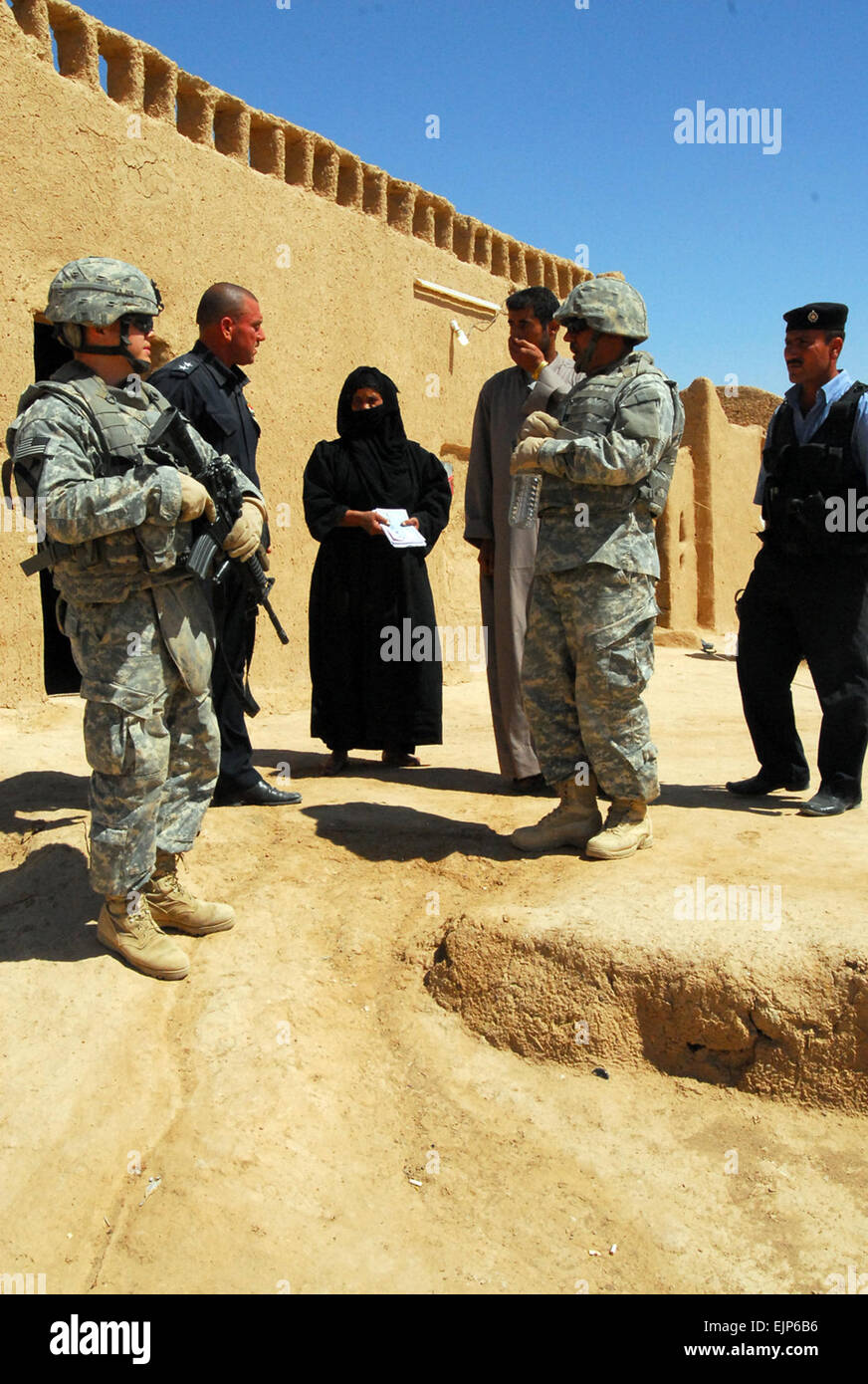 Lt. Abbas upper left of the Daquq, Iraq Police and 1st Lt. Christopher Minter left, from New Kent, Va., and a platoon leader in C Troop, 4th Squadron, 9th Cavalry Regiment, 2nd Brigade Combat Team, 1st Cavalry Division, speak with residents near the village of Zalla   Al Sabaee in Kirkuk province during a combined visit to the village to   conduct an assessment of essential services, May 31.          Small Iraqi villages targets for terrorist recruiting  #///-news/2009/06/22/23151-small-iraqi-villages-targets-for-terrorist-recruiting/?ref=home-headline-title5 Stock Photo