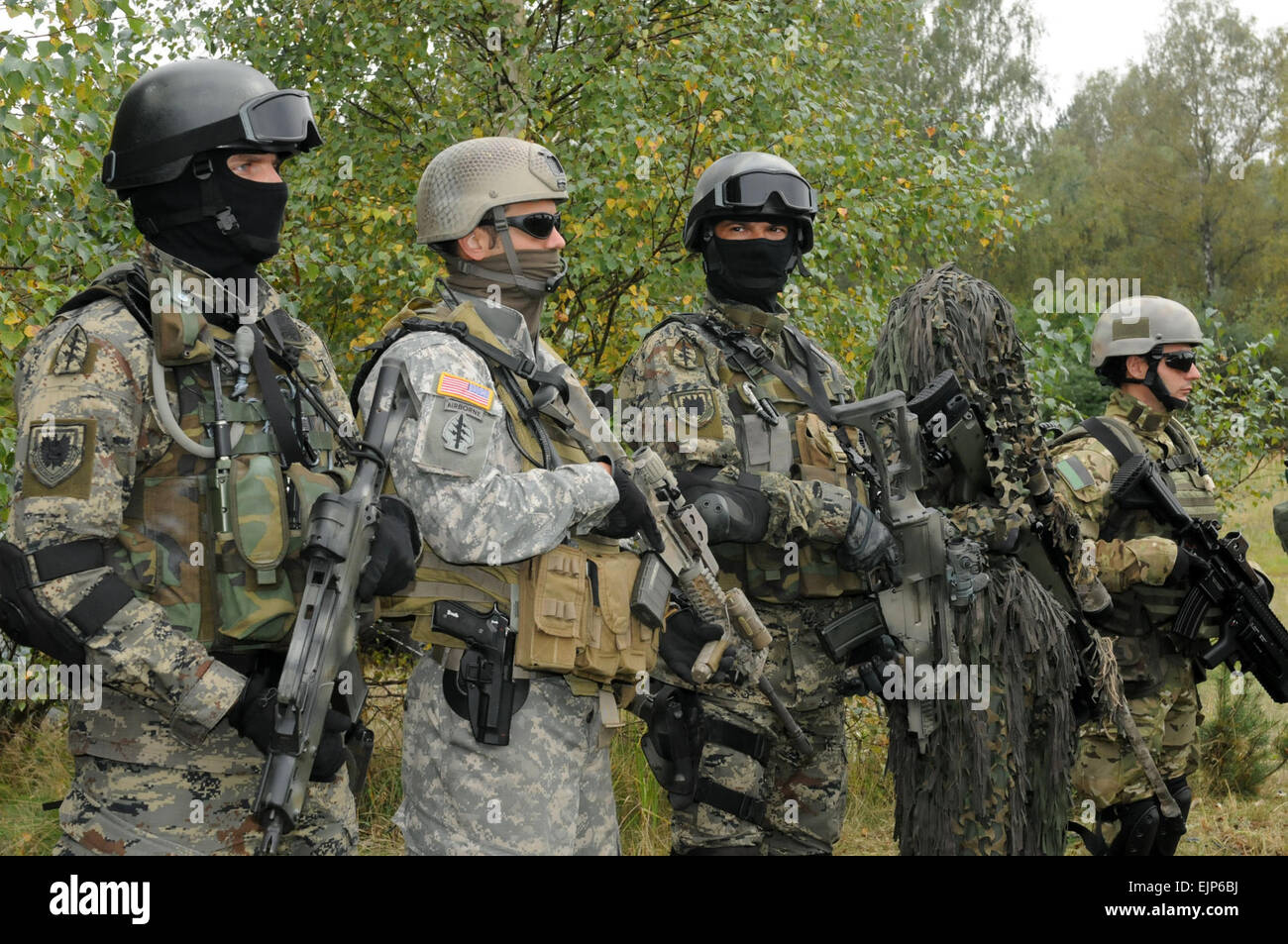 Special Operations Forces operators representing Croatia first and third from left, the U.S. second from left and Poland first and second from right, wear a variety of gear on Sept. 20 at Drawksow Pomorskie, Poland during a press conference as part of the official start of the Jackal Stone 10 exercise. Jackal Stone 10, hosted by Poland and Lithuania this year, is an annual international special operations forces SOF exercise held in Europe. Its objective is to enhance capabilities and interoperability amongst the participating special operations forces and as well as build mutual respect while Stock Photo