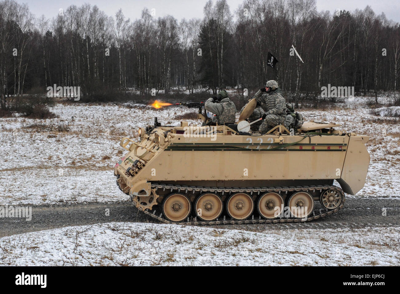 U.S. Army soldiers, assigned to Bravo Company, 1st Battalion, 4th Infantry Regiment, engage a target from a M113A2 armored vehicle during squad maneuver training at Grafenwoehr Training Area on Jan. 14, 2013. The soldiers of 1-4 Infantry are U.S. Army Europe's professional opposing force for training at the 7th Army Joint Multinational Readiness Center in Hohenfels, Germany.  They routinely hone their skills at Grafenwoehr's multi-functional live-fire facilities.  Staff Sergeant Pablo N. Piedra/released Stock Photo