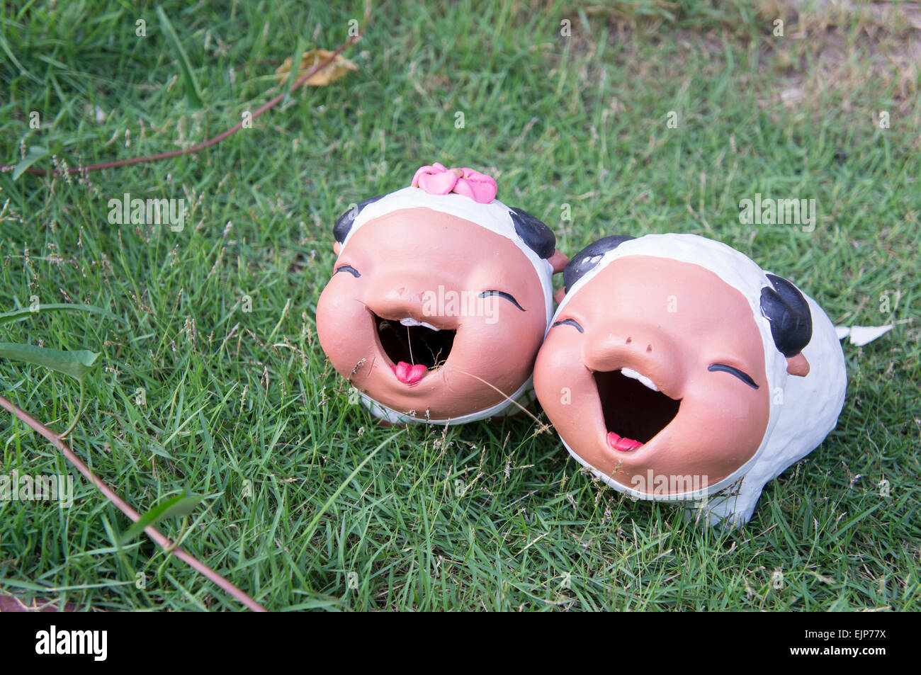 sheep ceramic doll garden grass two young Stock Photo