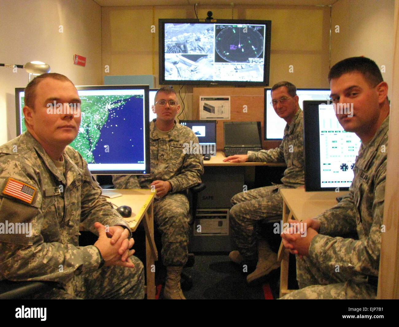Soldiers from Fort Bliss, Texas, try the prototype communication and control station for the Joint Land Attack Elevated Netted Sensor System. From left are 2nd Lt. Mike Jones, Staff Sgt. David Brandau, Master Sgt. Greg Heidenescher and Chief Warrant Officer 3 Chad Sneller.  Samuel Vaughn Stock Photo