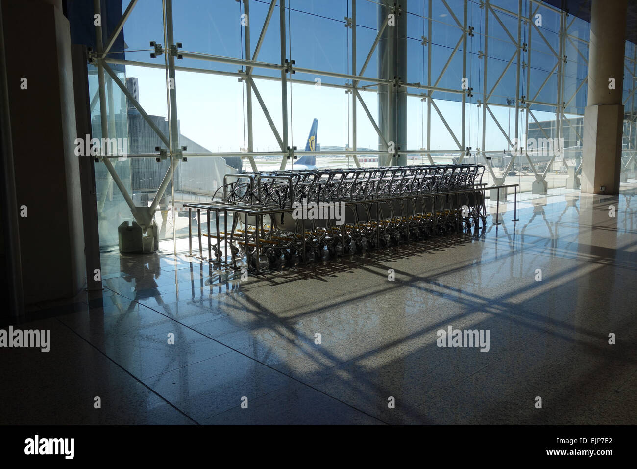 Empty luggage trolleys in departure area of Barcelona El Prat Airport